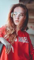 Fashion model wearing red hoodie with inscription los angeles photo