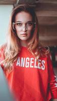 Fashion model wearing red hoodie with inscription los angeles photo