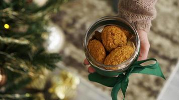 Oat cookies in a glass jar. Against the background of Christmas decor photo