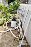 Sand filter plant at a pool in the backyard photo
