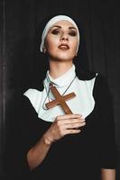Sexy nun prays indoor. Beautiful young holy sister. photo