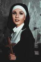 Sexy nun prays indoor. Beautiful young holy sister. photo