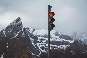 Traffic lights with red turned on the background of mountains photo