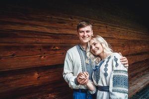Married couple outside a wooden house photo