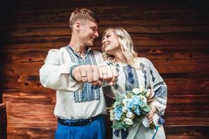 Married couple showing off rings photo