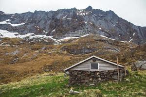 Old stone and wood house in the mountains photo