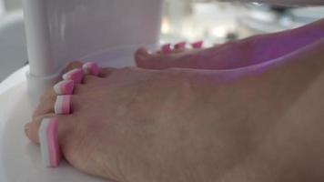 cuidados com os pés. mulher pés descalços massageando e prego cail na loja do spa. video