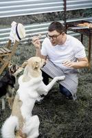 Caucasian man gives a snack to his dog, walking outdoors photo