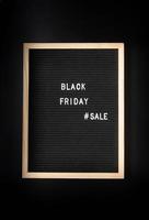 Text black friday sale on black letter board on black background photo