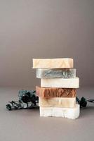 Stack of hand made soap and eucalyptus on gray background photo