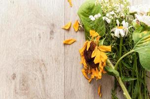 A bouquet of withered flowers on the floor photo