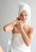 Young caucasian woman brushing her teeth in the morning photo