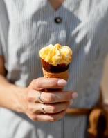 Woman hands holding fruity ice cream in hands photo