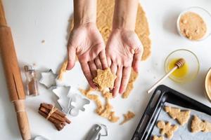 Woman hands baking cookies at the kitchen