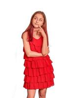 Teenage girl in a red dress in studio, isolated. photo