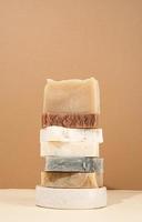 Tower stack of different handmade soaps on cream background photo