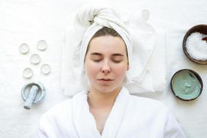 Relaxed woman having spa procedures using natural cosmetics photo