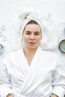 Relaxed woman having spa procedures using natural cosmetics photo