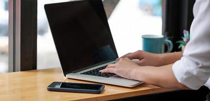 Cropped shot of a business woman sitting at modern office room photo