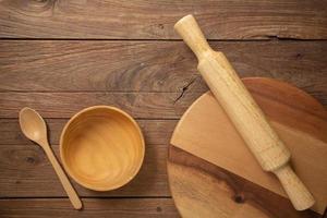Wooden cookware on Dark old wooden table texture background top view photo