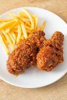 Spicy Korean fried chicken with fries photo