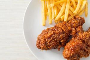 Spicy Korean fried chicken with fries photo