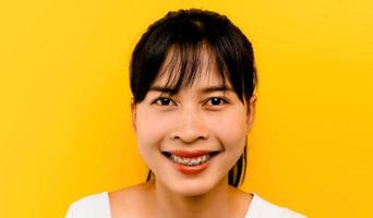 Asiática hermosa mujer sonriente después de la ortodoncia, tenga cuidado