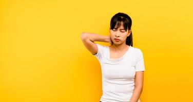 Beautiful Asian woman with neck pain from working hard photo