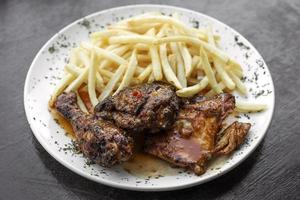 Portugués famoso piri piri picante pollo a la barbacoa con papas fritas foto
