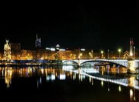 Central old town Lyon city and Rhone river side view at night in France photo