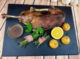 Roasted goose with beans and duchess potatoes photo