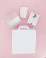 Paper bag for carrying things on pink background photo