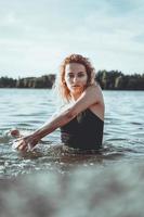 Young beautiful woman standing in the water. photo