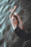 Young beautiful woman standing in the water. photo
