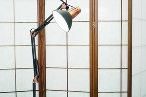 Screen with wood inlays in a beauty salon. Metal lamp photo