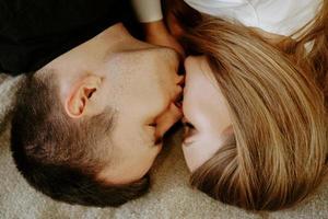 Close-up portrait of a young couple in bed at home photo