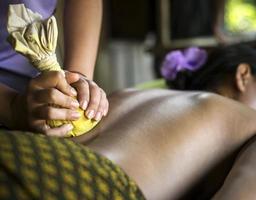 Asian massage spa natural organic beauty treatment with turmeric scrub paste photo