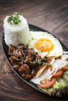 Cambodian traditional Khmer beef Lok Lak meal on wooden table photo