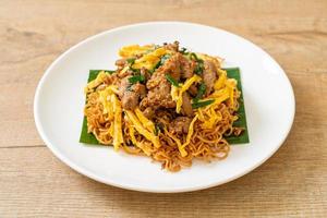 Stir-fried instant noodle with pork and egg photo