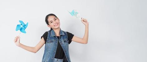 Teenage woman and paper windmill toys. teen with wind wheel stick photo