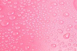 Close up water drops on pink background photo