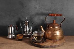 Group of Arabic tea in glass and metal tea pot photo