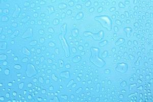 Close up water drops on blue background photo