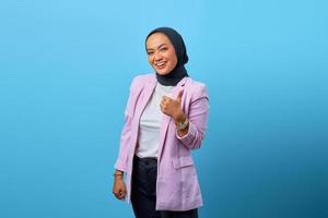 Portrait of attractive Asian woman showing thumbs up photo