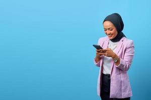 Attractive Asian woman using mobile phone with empty space