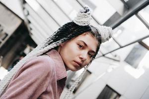 Young woman with futuristic looks. Girl with black and white pigtails photo