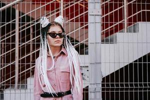 Portrait of beautiful cool girl over urban wall photo