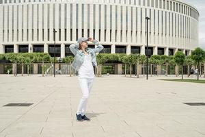 Happy young woman standing in the park photo