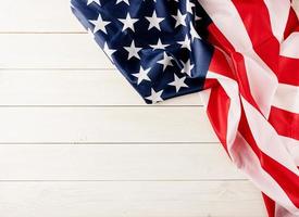 Top view of USA national flag on white wooden background, flat lay photo