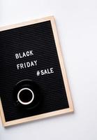 Text black friday sale on black letter board with cup of coffee on